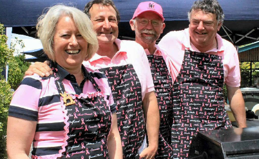 Glenis and Percy Pugliesi, Sam Reid and Morris Ryan look after the barbecue at the event.